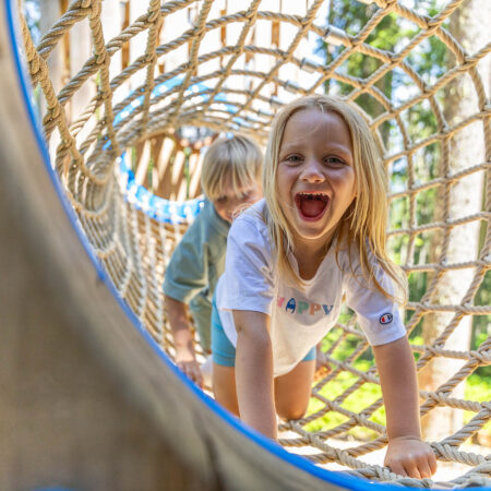 Kinder spielen an einem Wasserlauf aus Holz